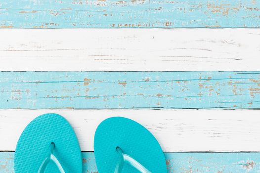 Summer holiday concept background with turquoise beach sandals on wooden deck 