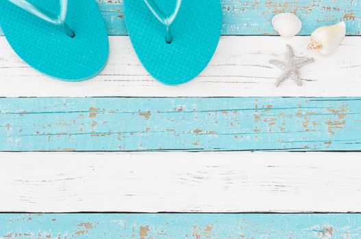 Summer vacation travel concept background with turquoise beach sandals on colored wood