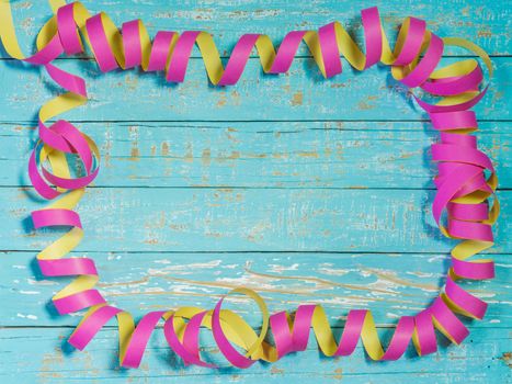 Streamers decoration on colored wood background for party or birthday celebration