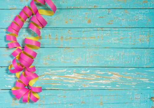 Streamers decoration on colored wood background for party or birthday celebration