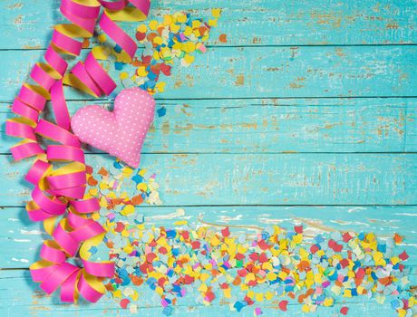 Colorful party, birthday or carnival celebration background with heart, streamers and confettis