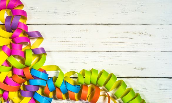 Multi-colored streamers decoration on white background for party, carnival or birthday celebration