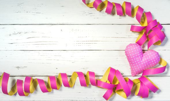 Party or birthday celebration background with streamers and pink heart decoration