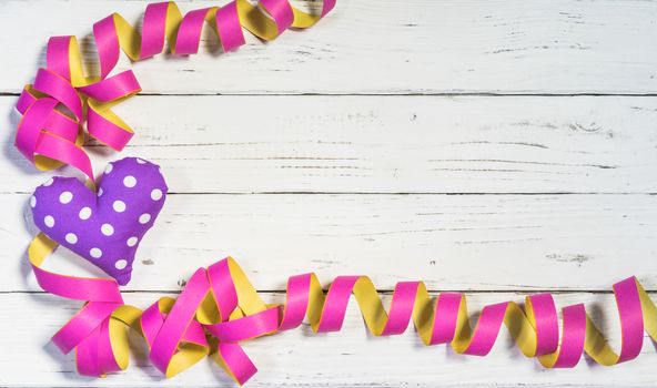 Celebration background with streamers and heart decoration with copy space