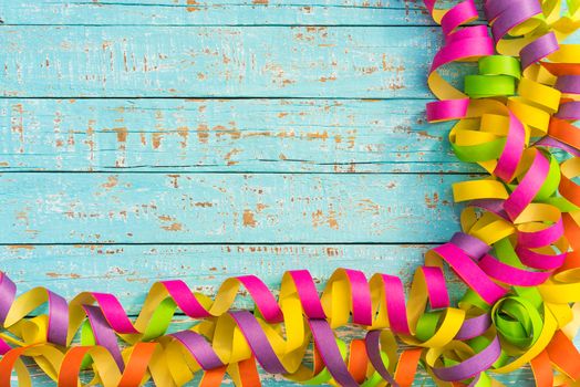 Multi-colored party, birthday or carnival celebration background with streamers and copy space