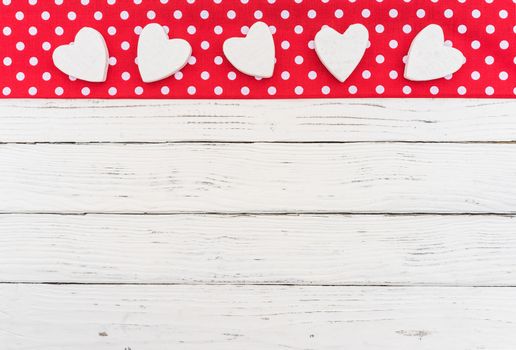 Romantic Valentine day background with many hearts on red fabric with copy space