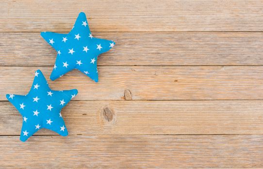 Blue stars decoration on wooden background with copy space