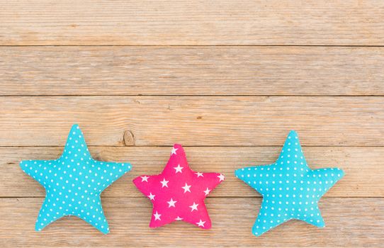 Fabric stars decor on wood background with copy space

