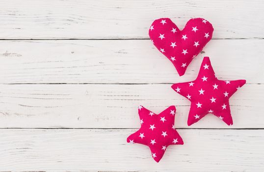 Stars and heart decoration on white wooden background with copy space