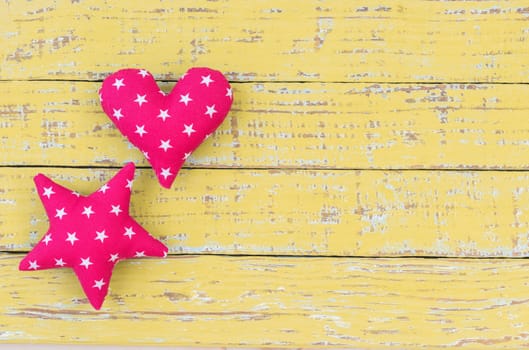 Star and heart decoration on vintage wooden background with copy space