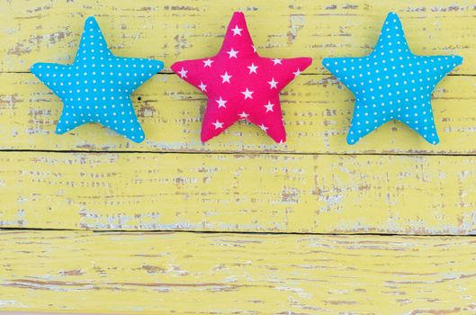 Fabric stars decor on vintage wooden background with copy space