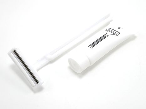 Disposable white plastic body manual shaver with blade attach to the head and shaving cream