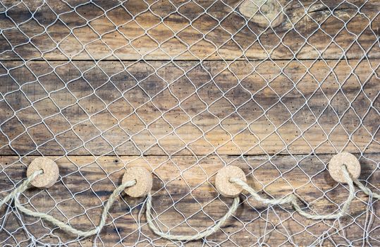 Fishing net background texture over rustic brown wood