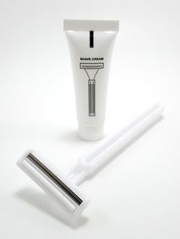 Disposable white plastic body manual shaver with blade attach to the head and shaving cream