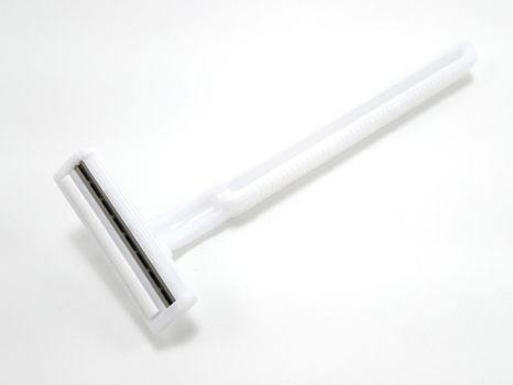 Disposable white plastic body manual shaver with blade attach to the head