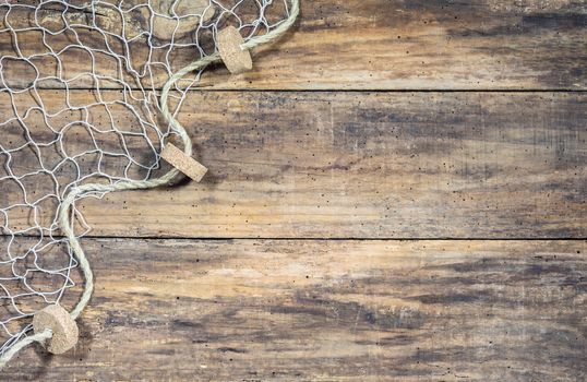 Fishing net background texture over rustic brown wood with copy space
