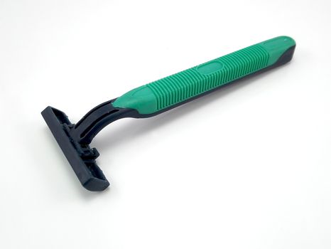 Disposable plastic green and black body manual shaver with blade attach to the head