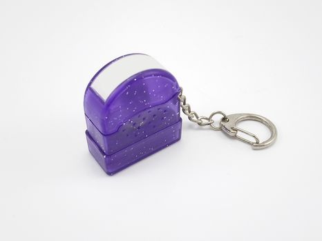 Small purple plastic glitters stamp with metal key ring and chain use for stamping on papers