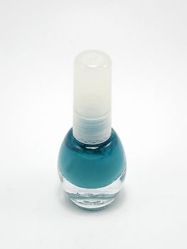 Turquoise nail polish with brush inside in the bottle use to coat ladies nails