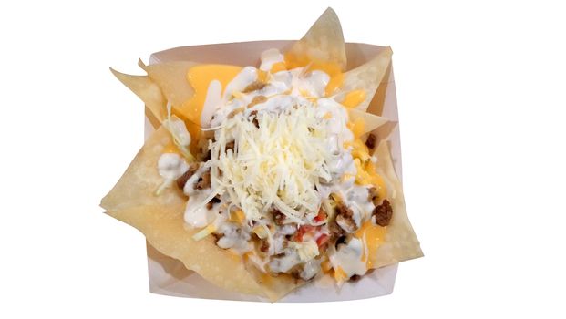 Nacho taco chips with ground beef, cheese, sauce, and tomatoes