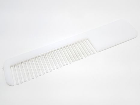 White disposable plastic hair comb use to fix and style the hair