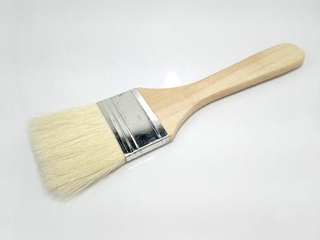 Wooden paint brush use to color paint the house serves as a tool