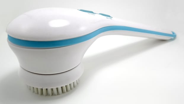 White electronic massager with rotating brush use for body relaxation