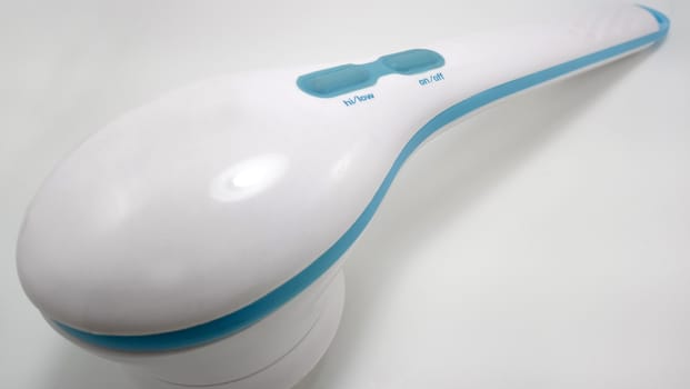 White electronic massager with rotating brush use for body relaxation