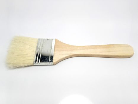 Wooden paint brush use to color paint the house serves as a tool