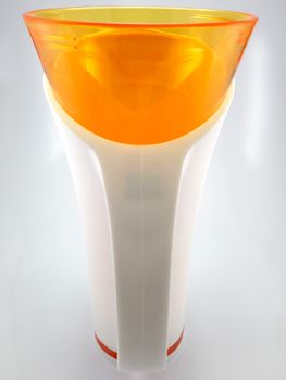 Orange and white color long plastic drinking cup with handle use to drink water content 