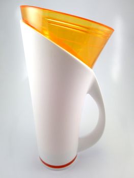 Orange and white color long plastic drinking cup with handle use to drink water content 