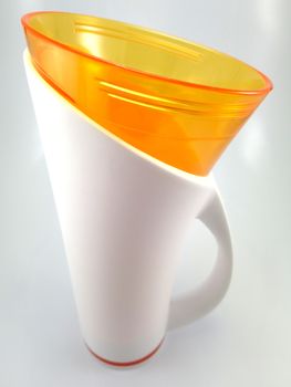 Orange and white color long plastic drinking cup with handle use to drink water content 