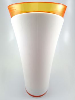 Orange and white color long plastic drinking cup with handle use to drink water content 