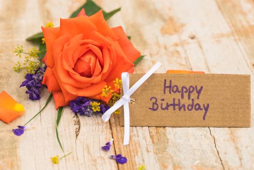 Bunch of orange rose flower and Happy Birthday greeting card
