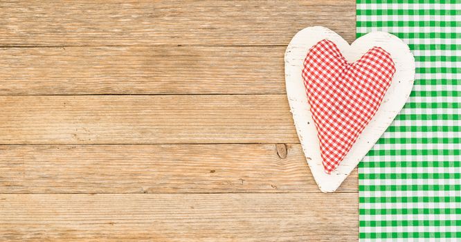 Rustic red heart on wooden background with copy space