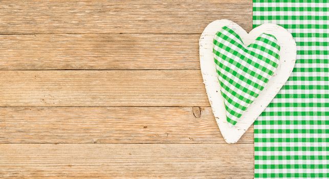Rustic green heart on wood with copy space