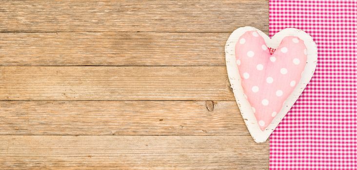 Romantic pink heart on wooden background with copy space