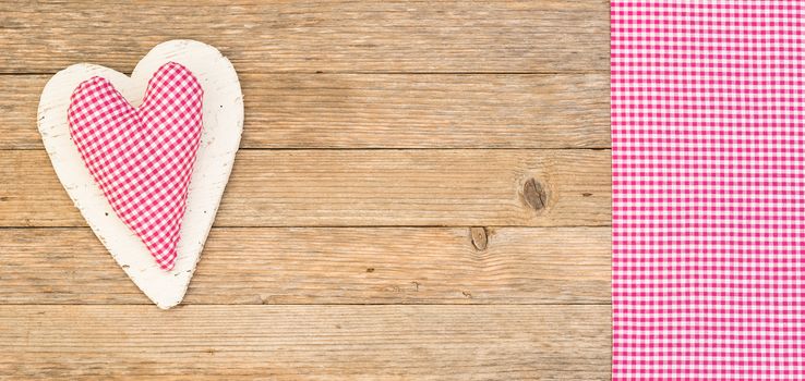 Romantic rustic pink heart on wood background with copy space