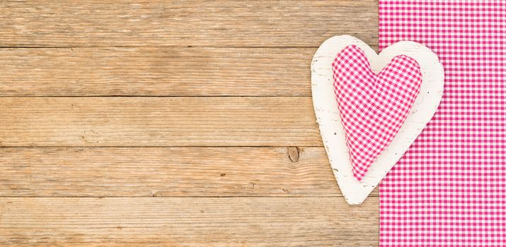 Romantic pink heart on wooden background for Valentine card with copy space