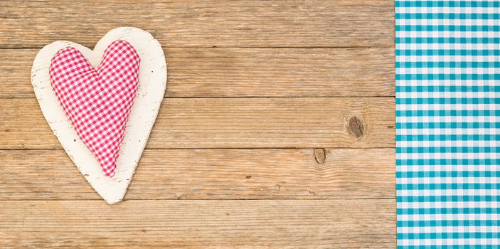 Rustic heart on wooden background with copy space