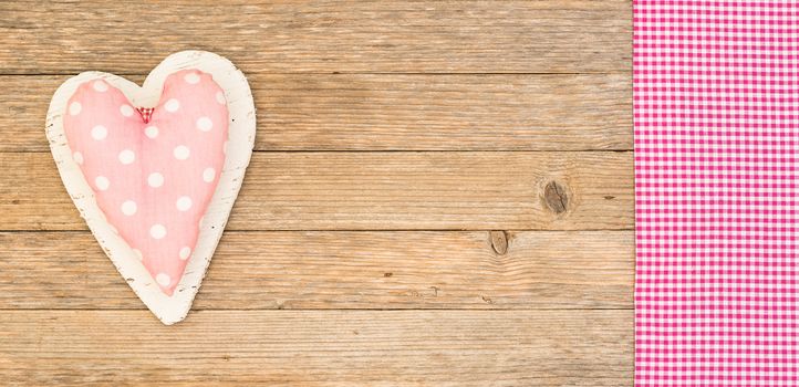 Romantic pink heart on wooden background for Valentine card with copy space