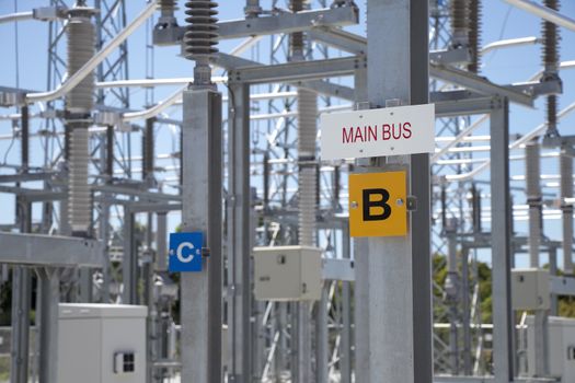 Sign showing main bus of a three-phase electrical system in the power substation.