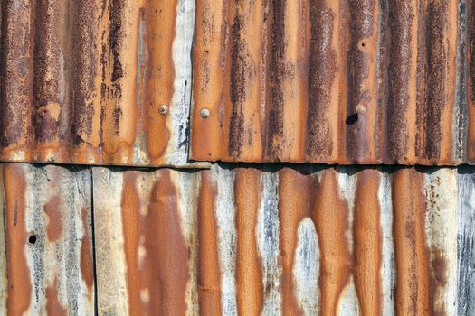 Distressed old corrugated rust covered iron fence texture background