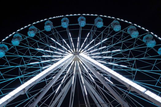 luminous ferris wheel against the night sky