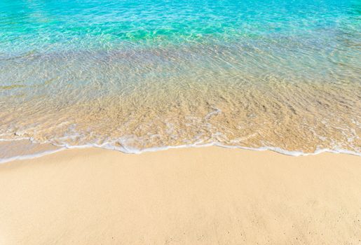 Close-up of sandy beach with soft sea wave