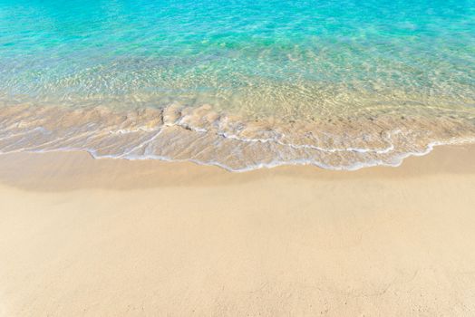 Beach holiday background texture of soft sea water wave on sandy beach