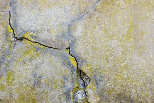 Cracked cement wall, detail of a wall damaged by the passage of time, outside facade