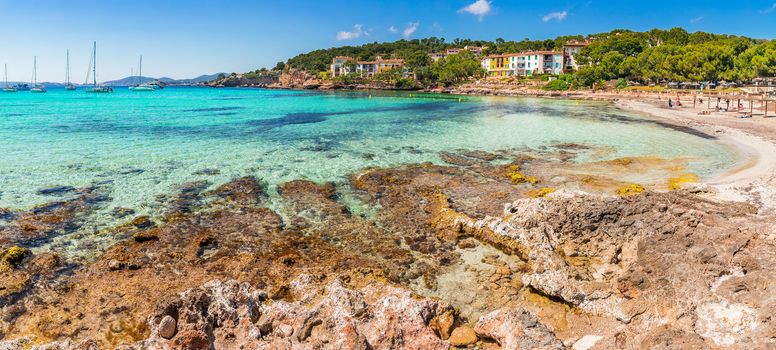 Summer holiday on Majorca island, beautiful panorama view seaside beach bay with sailing yachts boats, Spain Mediterranean Sea