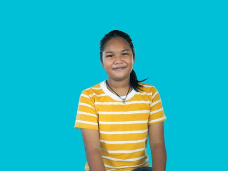 Portrait of Asian woman In a yellow shirt isolated on a blue background.
Happy people concept.