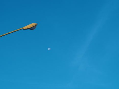 The street light tower on the background is blue sky And there is a small moon in the middle
Energy and nature concepts.
Minimal image.